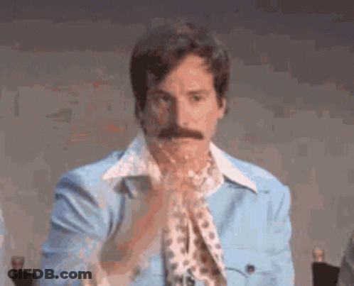 Man With Mustache In Blue Jacket And Leopard Print Shirt GIF