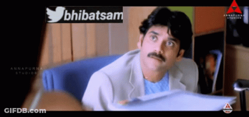 Man With Mustache In Front Of Abhatsam Sign GIF