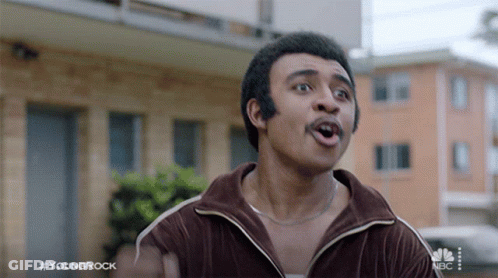 Man With Mustache In Front Of Building Hashtag YoungRock GIF