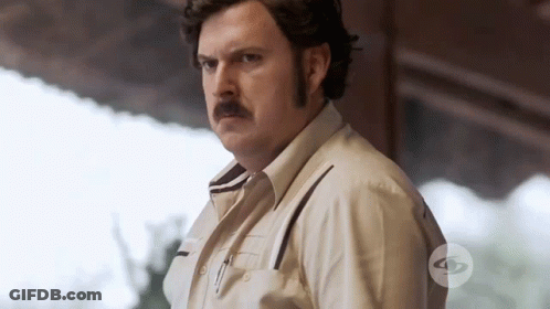 Man With Mustache In Front Of TV Sign GIF