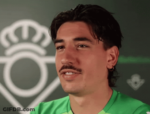 Man With Mustache In Green Shirt And White Crown GIF