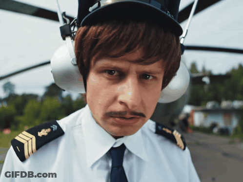 Man With Mustache In Pilot Hat And Ear Protectors GIF