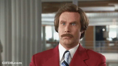 Man With Mustache In Red Suit Making Funny Face GIF