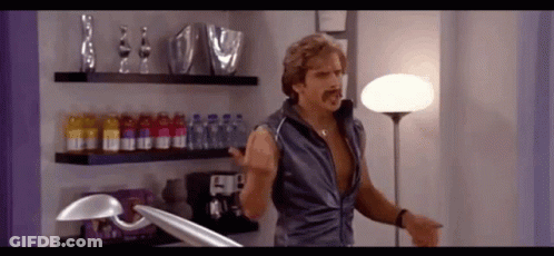 Man With Mustache In Room With Lamp And Bottles GIF