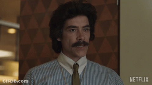 Man With Mustache In Striped Shirt And Tie With Netflix Logo GIF