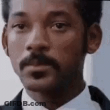 Man With Mustache In Suit And Tie Looking At Camera GIF