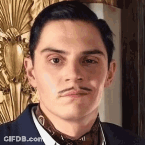 Man With Mustache In Suit And Tie Making Face GIF