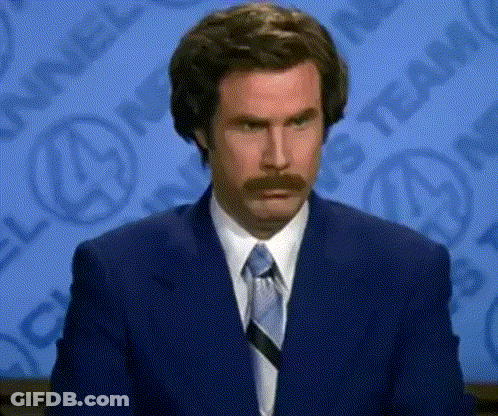 Man With Mustache In Suit And Tie Making Funny Face GIF