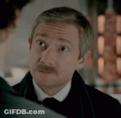 Man With Mustache In Tuxedo Looking At Another Man GIF