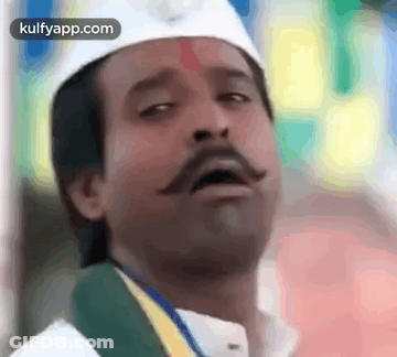 Man With Mustache In White Hat And Green Scarf GIF