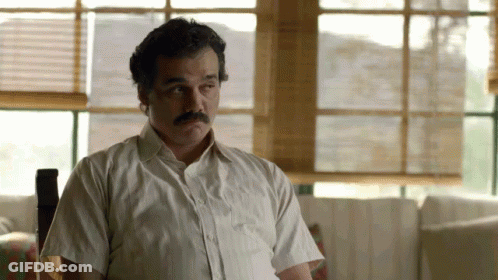 Man With Mustache In White Shirt Sitting By Window GIF