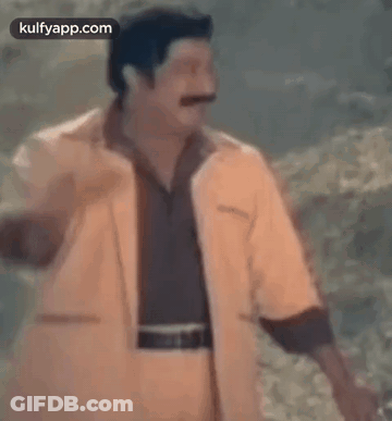 Man With Mustache In Yellow Jacket And Brown Shirt GIF