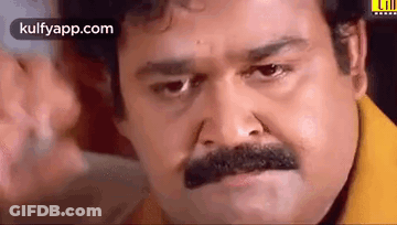 Man With Mustache In Yellow Shirt Making Face GIF