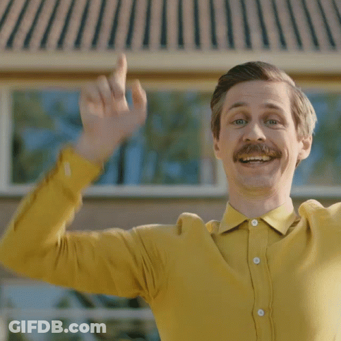 Man With Mustache In Yellow Shirt Waving GIF