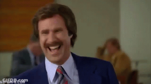 Man With Mustache Laughing In Suit And Tie GIF