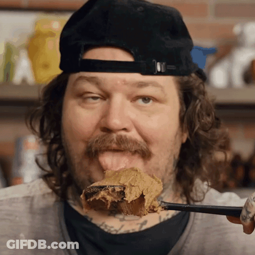 Man With Mustache Licking Spoonful Of Peanut Butter GIF
