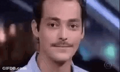 Man With Mustache Looking At Camera GIF