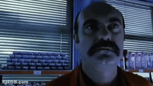 Man With Mustache Looking At Camera GIF