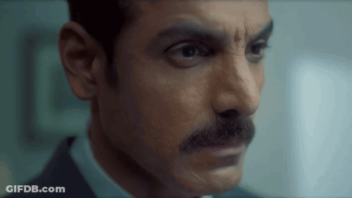 Man With Mustache Looking At Camera GIF