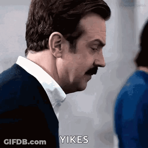 Man With Mustache Looking Down Saying Yikes GIF