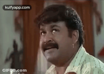 Man With Mustache Making Funny Face At Table GIF