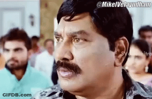 Man With Mustache Making Funny Face In Crowd GIF