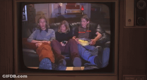 Man With Mustache Next To Man In Orange And Black Shirt GIF