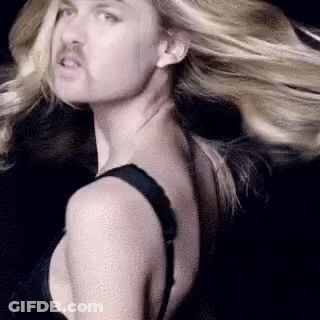 Man With Mustache Next To Woman In Bra GIF