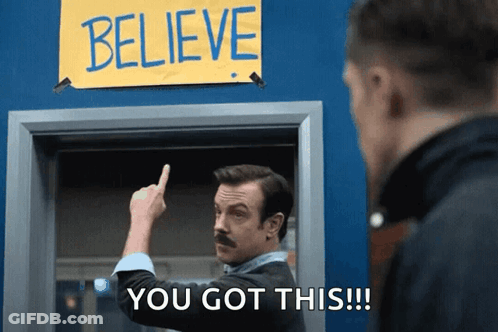 Man With Mustache Pointing At Believe Sign GIF
