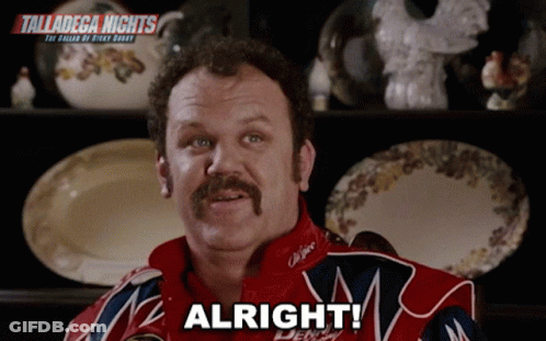 Man With Mustache Saying Alright In Front Of Shelf Of Plates GIF