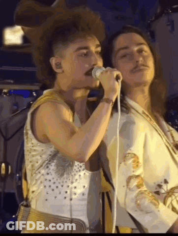 Man With Mustache Singing Into Microphone GIF
