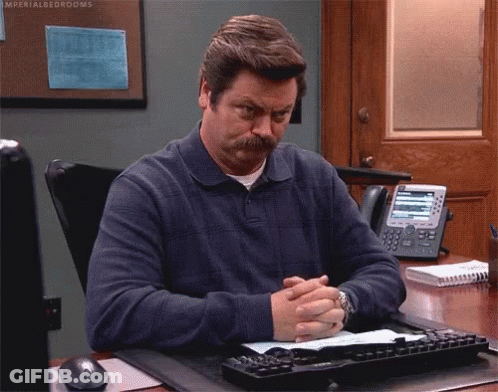 Man With Mustache Sitting At Desk Hands Folded GIF