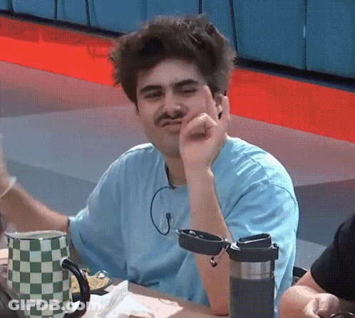 Man With Mustache Sitting At Table GIF