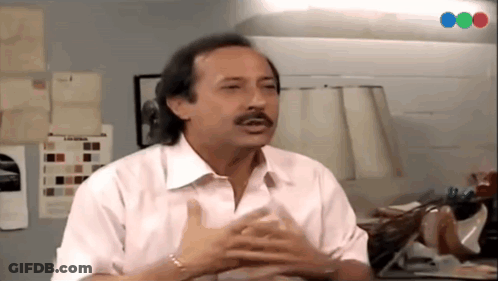 Man With Mustache Sitting At Table GIF
