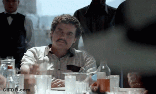 Man With Mustache Sitting At Table GIF