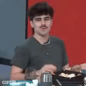 Man With Mustache Sitting At Table GIF