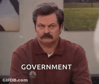 Man With Mustache Sitting In Front Of Government Wall GIF