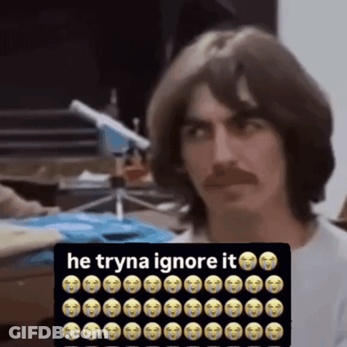 Man With Mustache Sitting In Front Of Sign Saying He Tryna Ignore It GIF