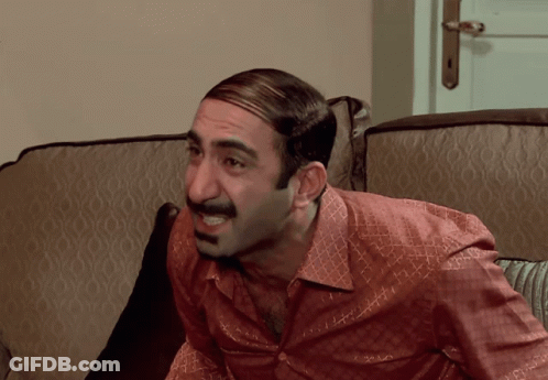 Man With Mustache Sitting On Couch Mouth Open GIF