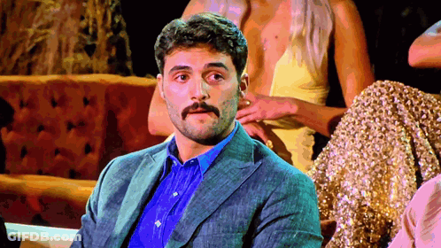 Man With Mustache Sitting With Women GIF