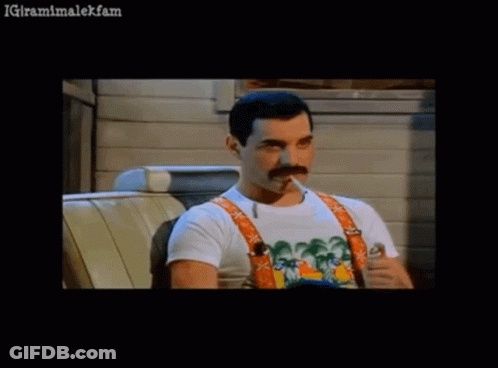Man With Mustache Smoking Cigarette In Chair GIF