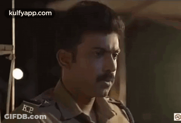 Man With Mustache Smoking Cigarette In Dark Room GIF