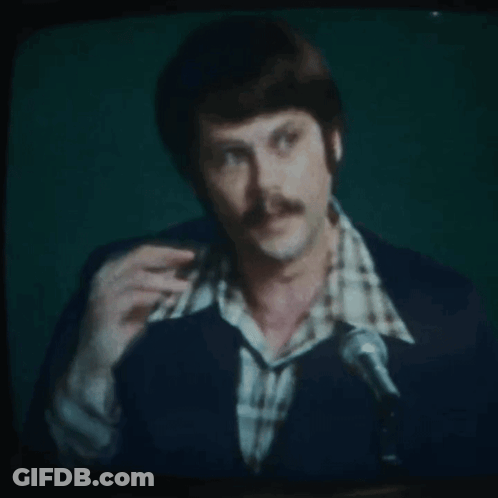 Man With Mustache Speaking Into Microphone On TV GIF