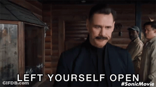 Man With Mustache Standing Before Group Saying Left Yourself Open GIF