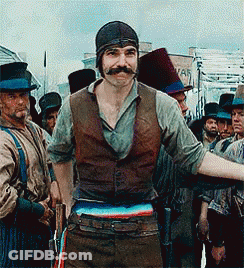Man With Mustache Standing In Front Of Group GIF
