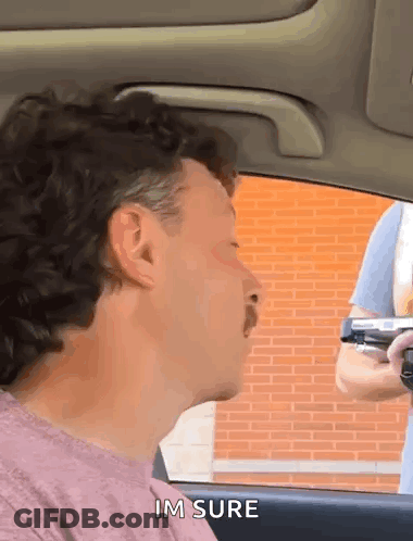 Man With Mustache Talking To Gun Holder GIF