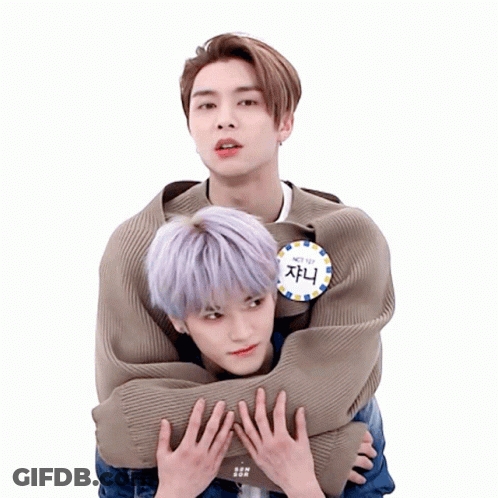 Man With NCT 127 Badge Hugging Another Man GIF