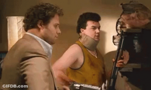 Man With Neck Brace Talking To Man In Tank Top GIF