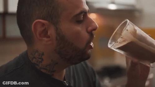 Man With Neck Tattoo Drinking From Cup GIF