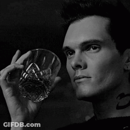 Man With Neck Tattoo Holding Glass Of Whiskey GIF
